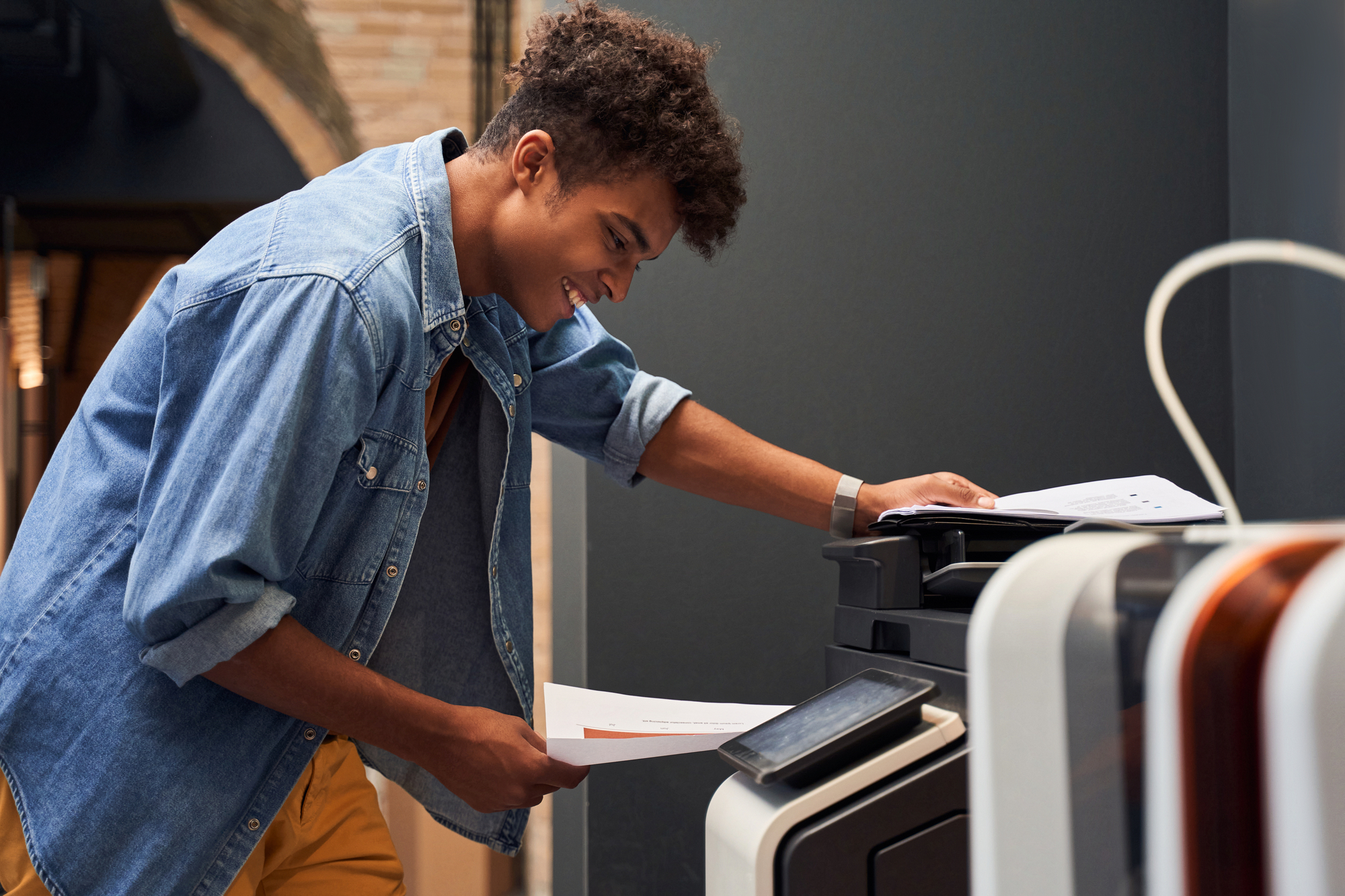 Man Working On Multifunction Printer